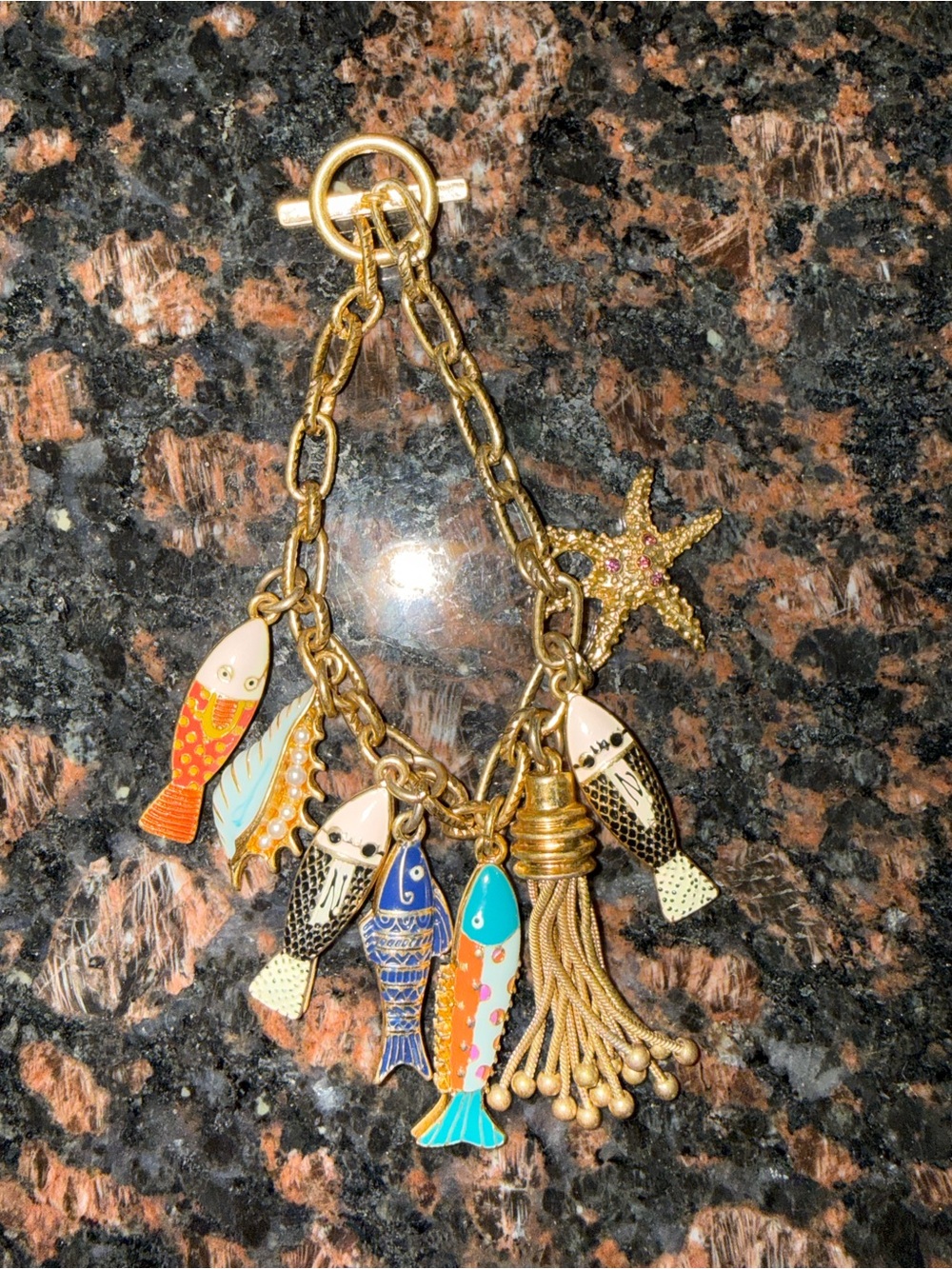 Gold Tone Multicolor Fish Charm Bracelet with Starfish, Tassel, and Conch Shell